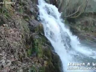 Á châu đôi sucks con gà trống qua waterfall